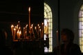 People light candles during festive prayer in church Royalty Free Stock Photo